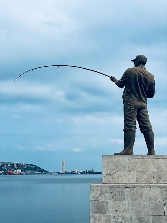 Statue of a Person Fishing · Free Stock Photo
