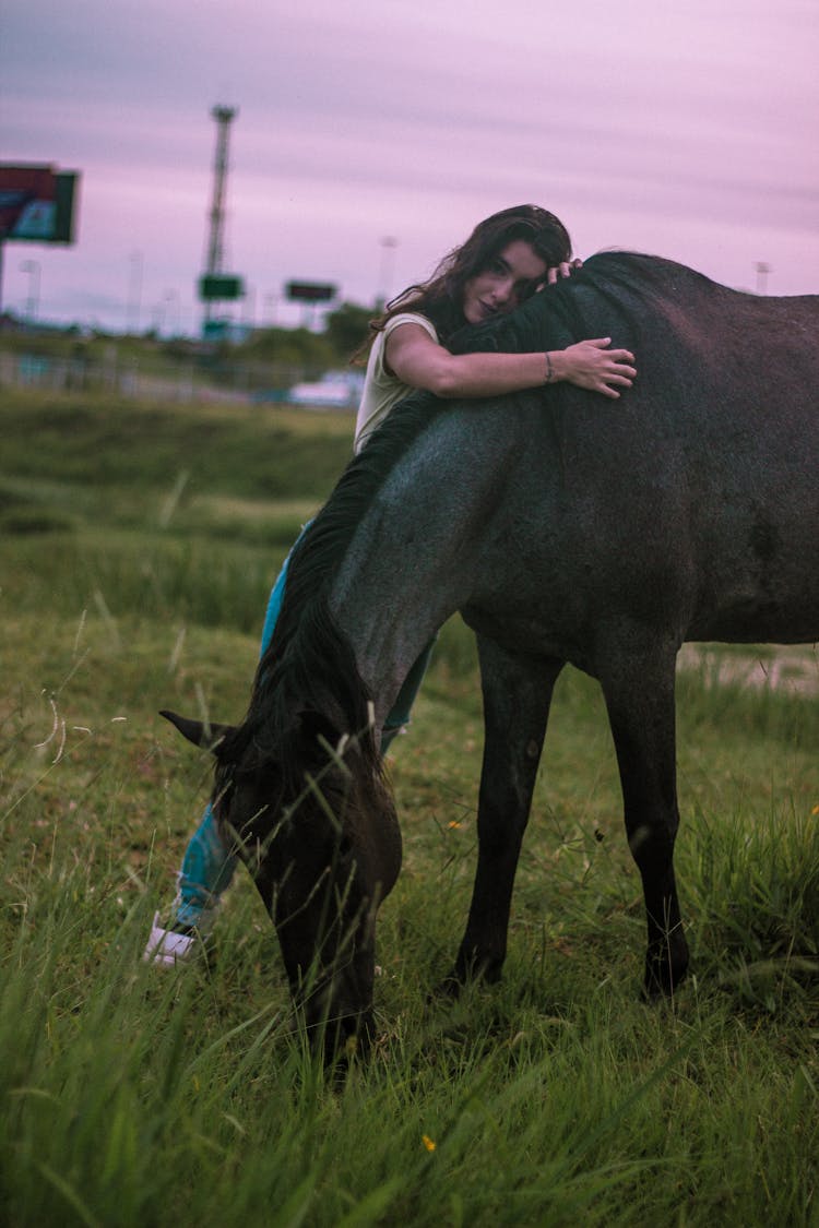 Woman Hugging The Black Horse 