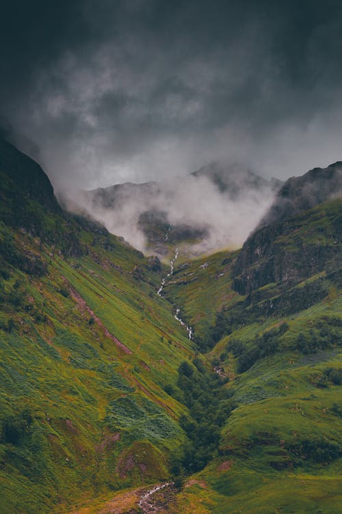 Free Green Mountains Under Gray Clouds Stock Photo