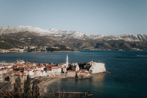 Free Discover the stunning coastal view of Budva, Montenegro featuring ancient architecture and scenic mountains. Stock Photo