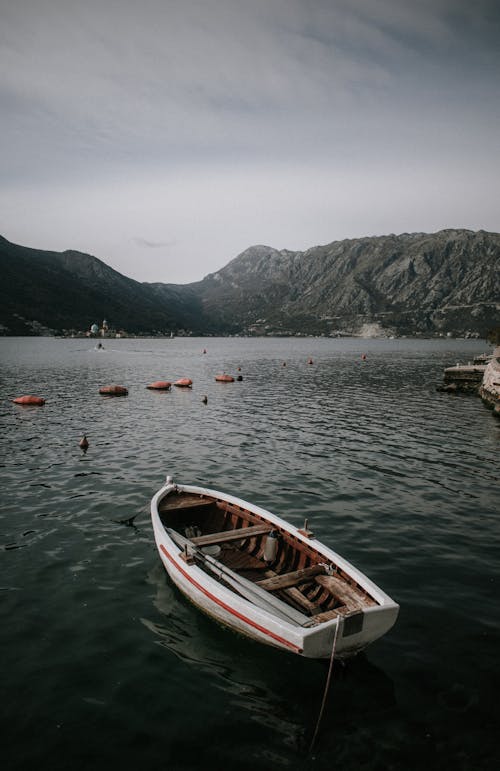 An Empty Rowboat Docked on Lake