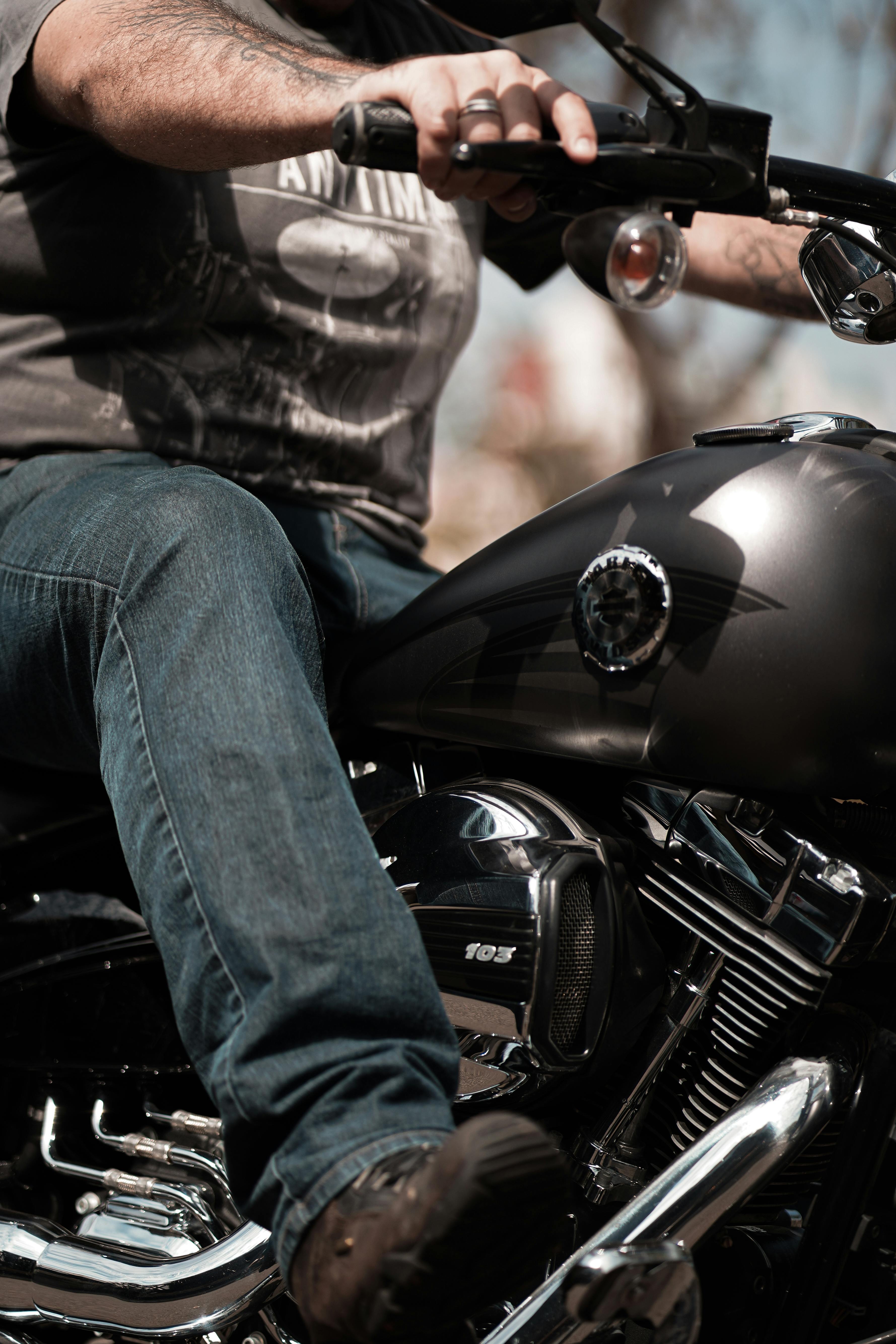 Dynamic close-up of a man riding a Harley-Davidson motorcycle outdoors.