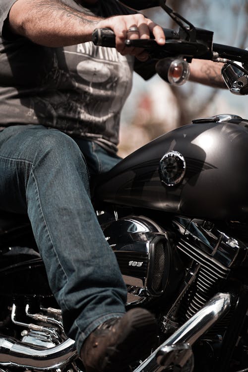 Free A Man in Denim Jeans and Shirt Riding a Motorcycle Stock Photo