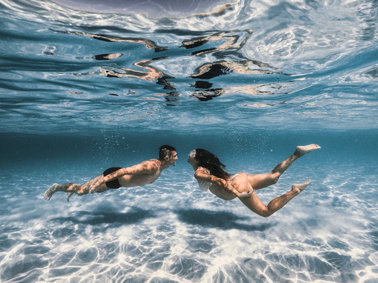 A Couple Swimming Underwater