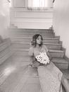 A Girl Sitting on the Stairs Matching Her Dress