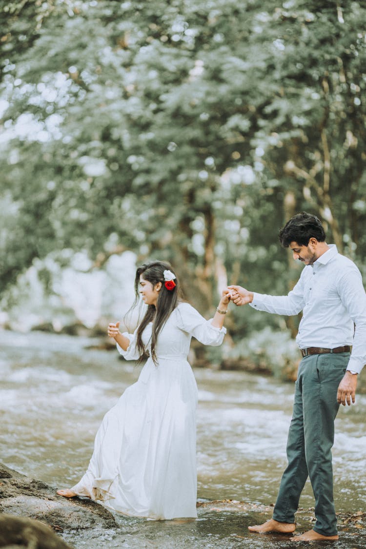 A Couple Crossing A River 