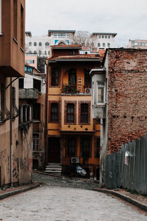 Free Quaint narrow street with colorful historic buildings, perfect for urban exploration. Stock Photo