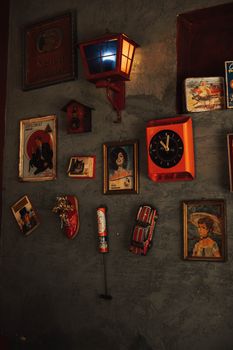 Eclectic collection of vintage art and decor pieces on a textured wall.