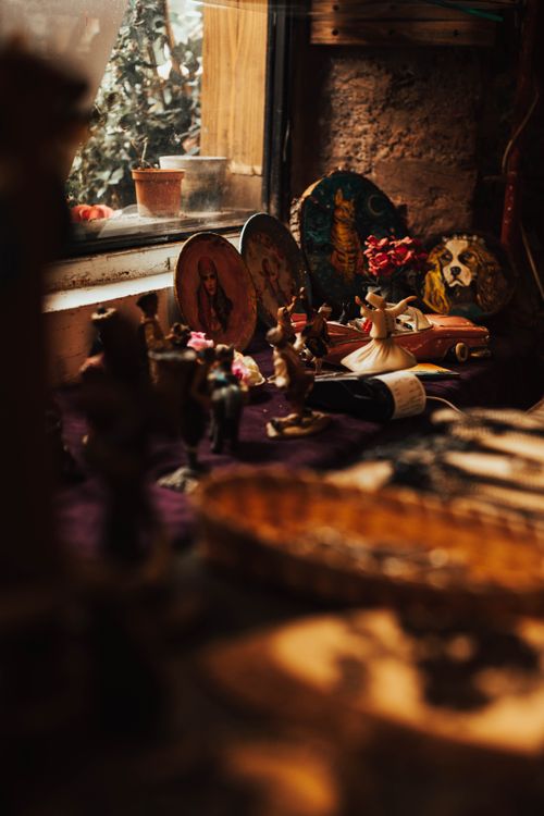 Free Charming vintage decorations on an indoor windowsill with soft natural light. Stock Photo