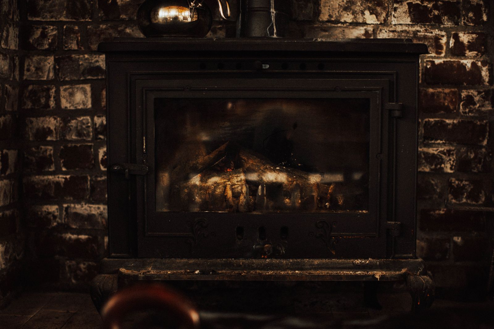 Cast iron fireplace in brick hearth