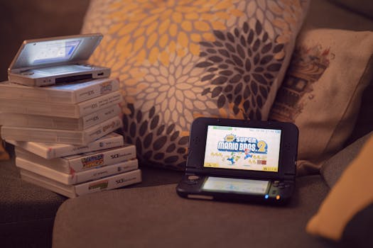 Two handheld gaming consoles on a sofa with game cartridges, creating a cozy game night mood.