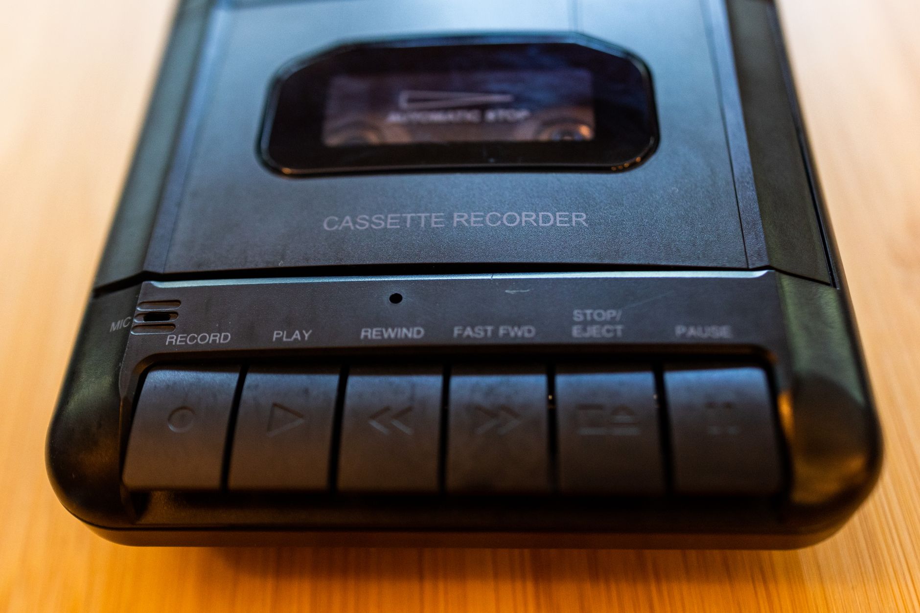 close-up of a player recording slot results on paper beside a glowing laptop