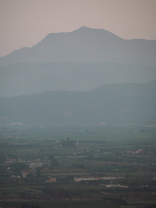 Hazy Panorama of a Mountain Valley with a Village
