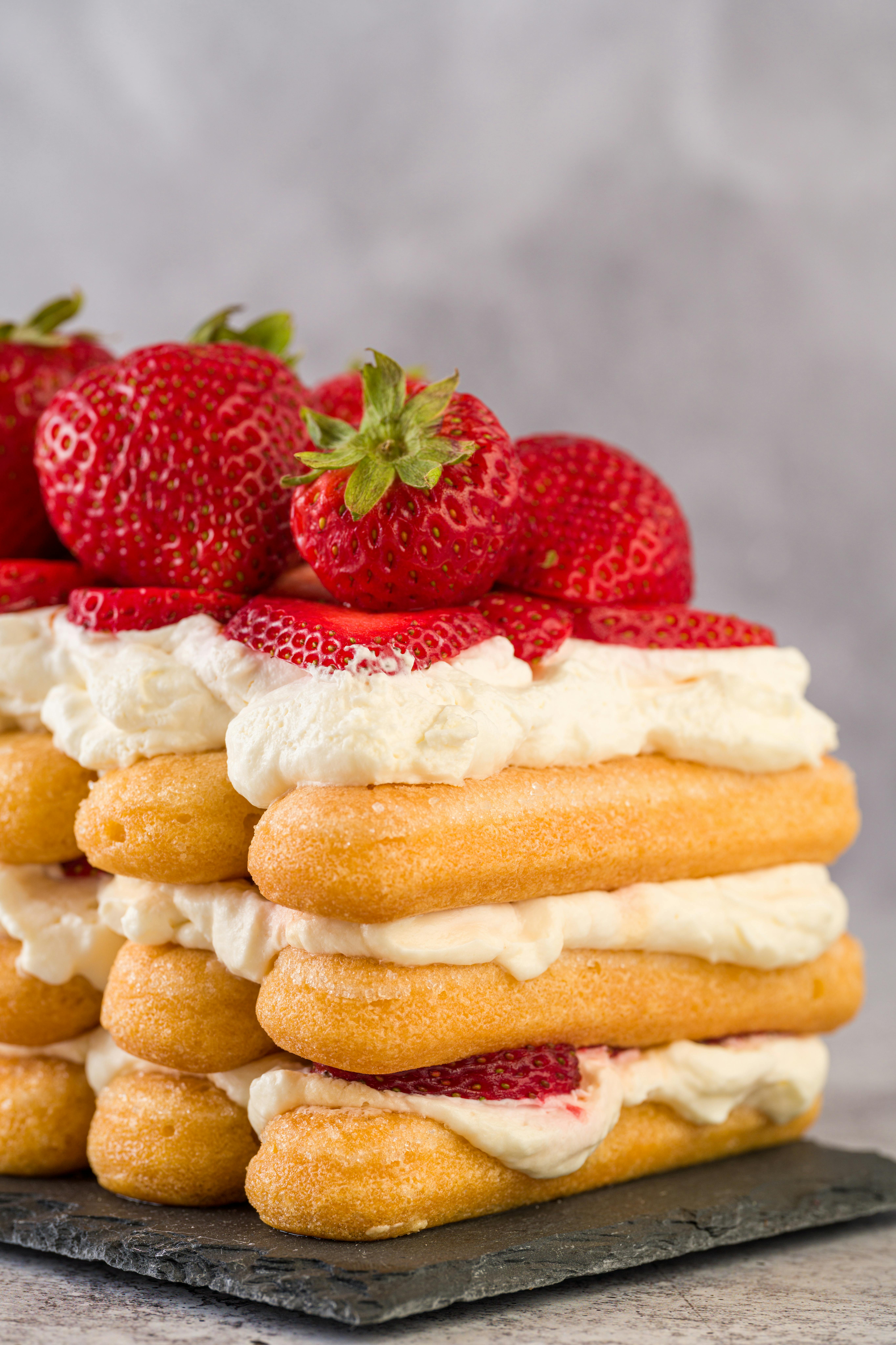 Diplomat Cake or Charlotte Cake with Strwaberries and Lady Fingers in Baking  Pan on a Wooden Table with Yellow Background / Focus Stock Image - Image of  food, background: 138065587