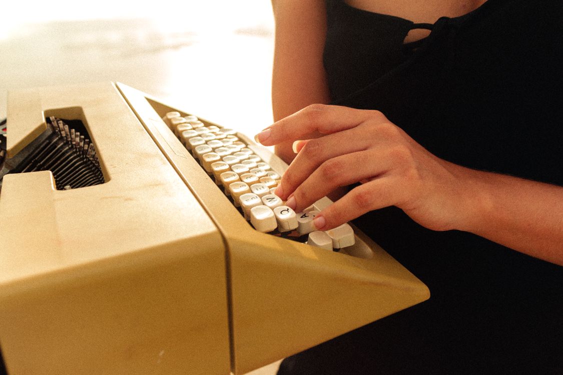 Someone Using Typewriter Photo of a Person's Hand Using a Typewriter · Free Stock Photo