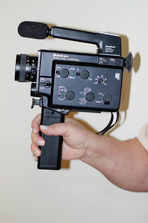 A Person Hand Holding A Video Camera