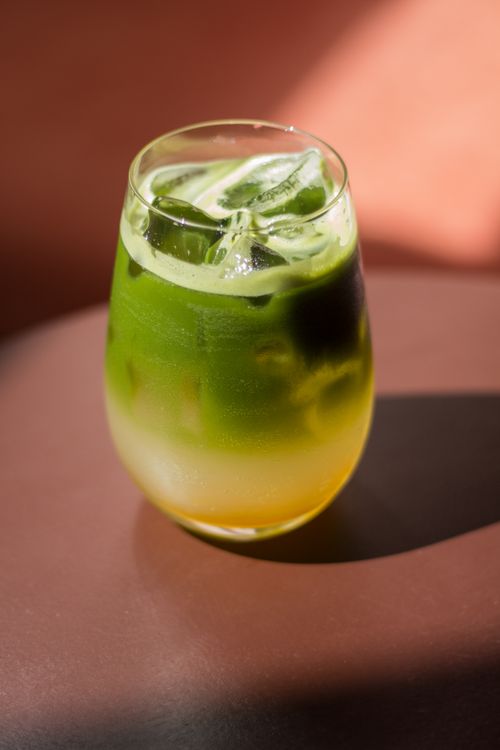 Free Inviting iced matcha latte with vibrant layers, perfect for a refreshing beverage treat. Stock Photo
