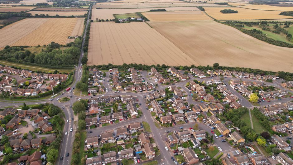 Incredible 60 Minute Thames & Medway Estuary Helicopter Tour Review: A Stunning Hour Over England's Historic Waterways Review 2026 - Drone shot showing a residential area and farmlands in Luton, UK.
