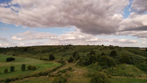 Free Aerial view of the lush green hills and dramatic clouds in Luton, England. Stock Photo