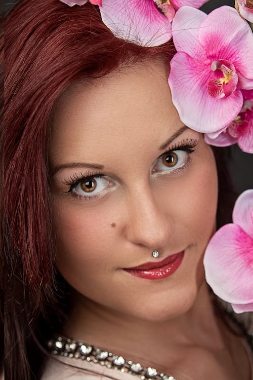 Free Portrait of a Beautiful Woman Near Pink Flowers Stock Photo