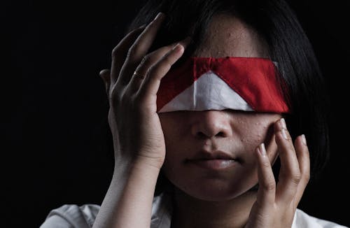 White and Red Cloth Covering the Woman's Eyes 