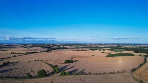 Free Aerial Shot of Cropland Under the Clear Blue Sky  Stock Photo