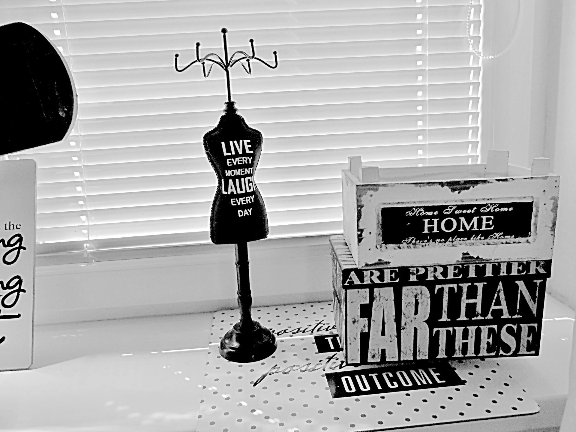 Black and white image featuring decor with motivational quotes and wooden boxes.