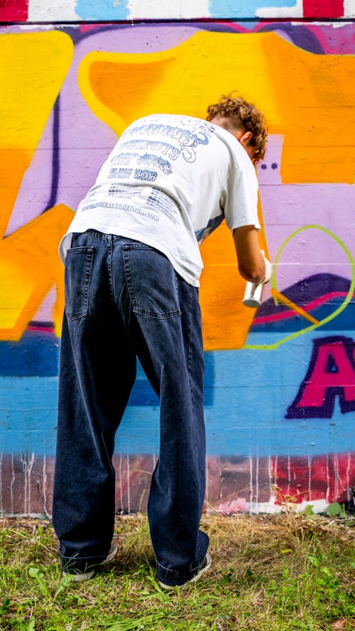 A Person Painting a Wall with Spray Paint