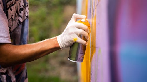 A Person Spraying on a Wall 