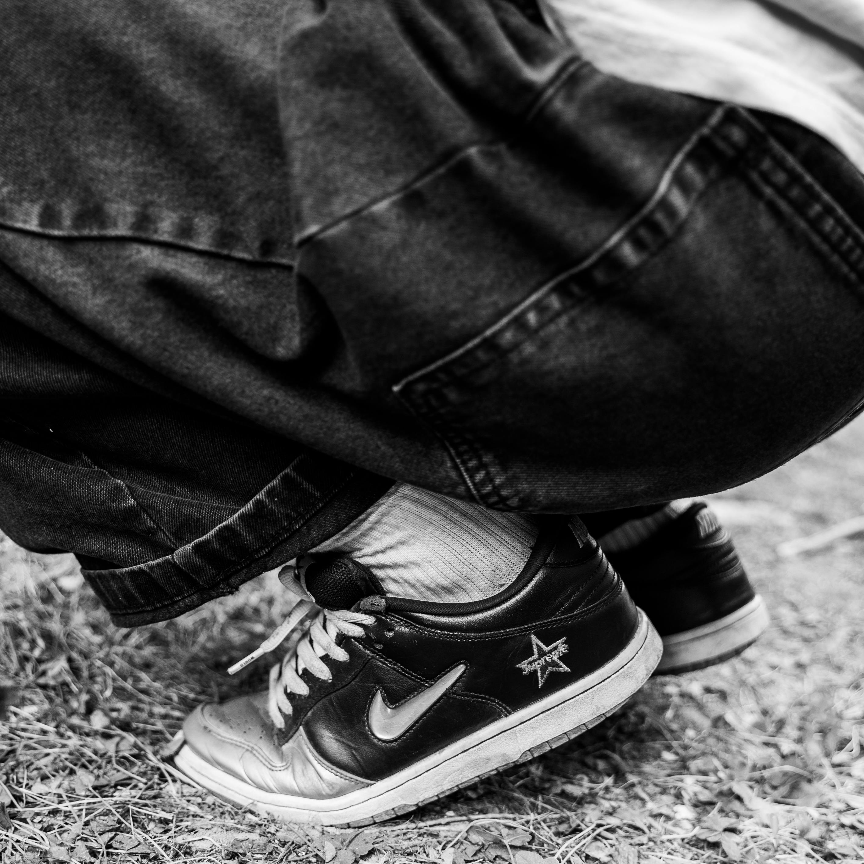 A Person Wearing Black Sneakers