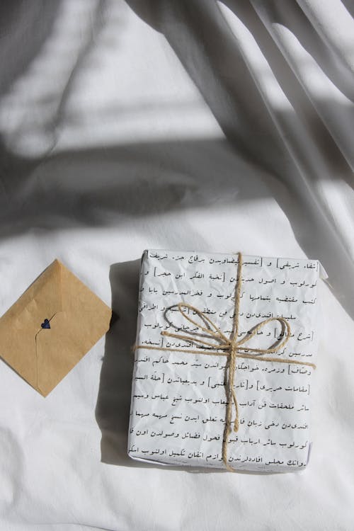 A White Gift Box on the Bed