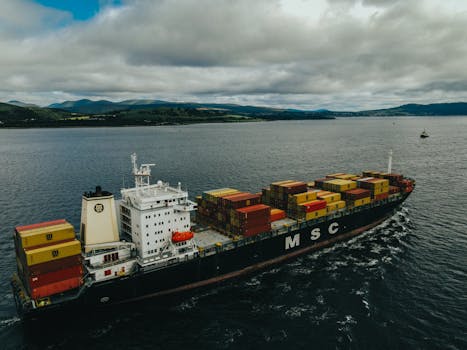 A cargo ship laden with containers sails through the waters near Inverclyde, Scotland.