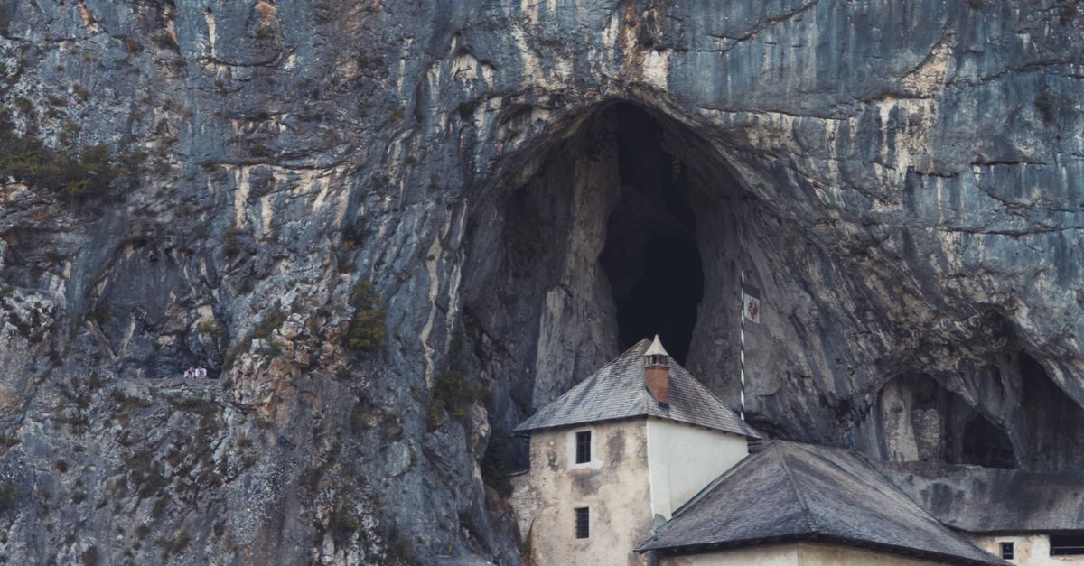 Concrete Building Near a Cave · Free Stock Photo
