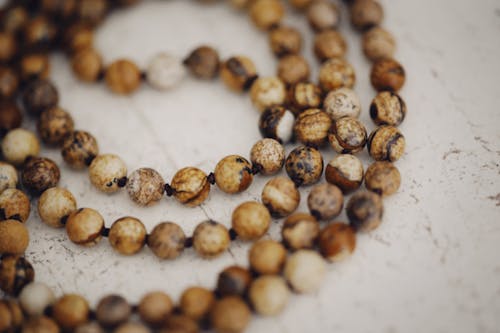 Close-Up Photo of Beads on White Surface