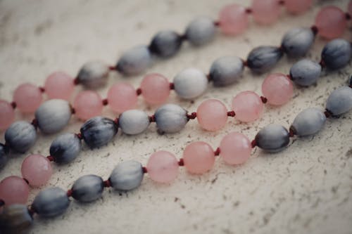 Blue and Pink Beads on White Surface