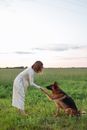 A Woman Training Her German Shepherd