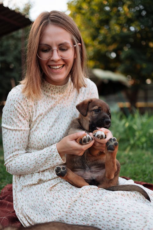 Free A Woman Playing with Her Puppy Stock Photo