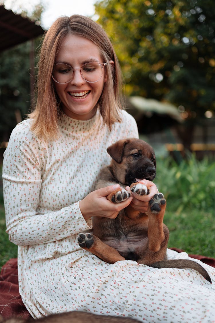 A Woman Playing With Her Puppy