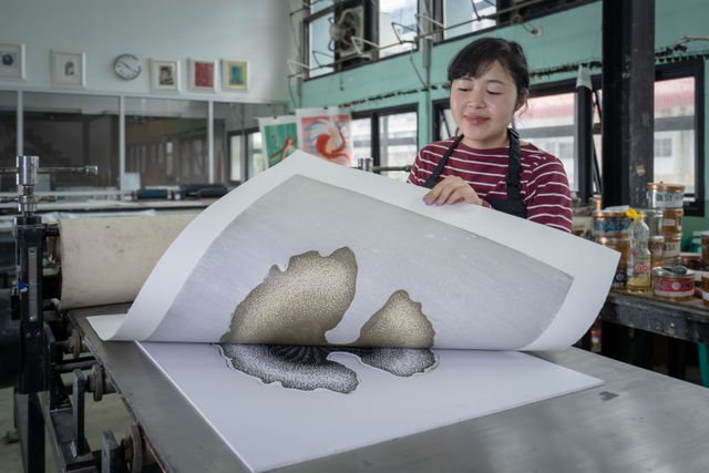 Artist at work in a printmaking studio with a press — Thoranin Duangsin on Pexels