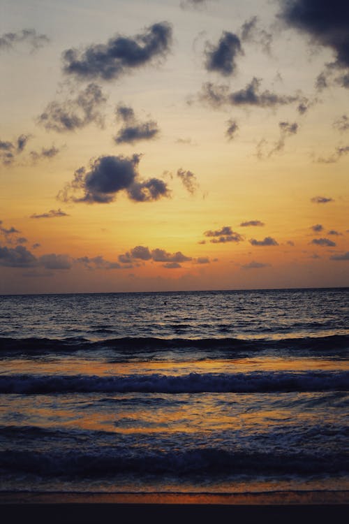 Sea Waves Crashing on Shore during Sunset