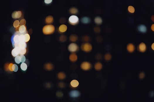 Abstract urban photo capturing colorful blurred bokeh lights at night.