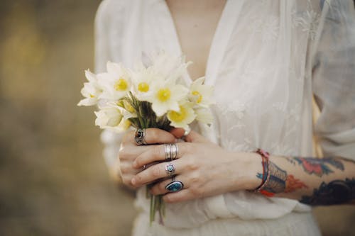 Person Holding White Flower Bouquet