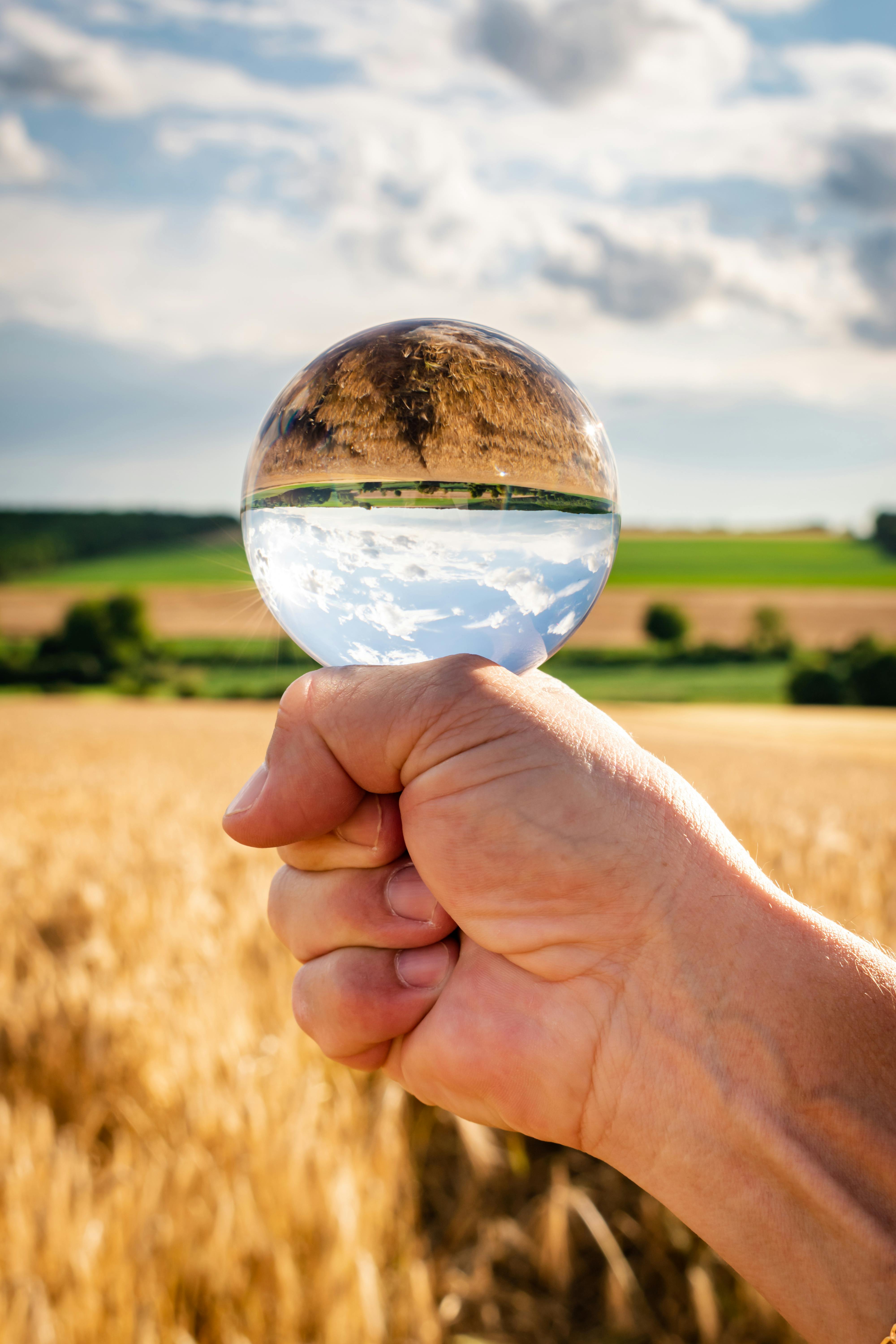a person holding clear glass ball