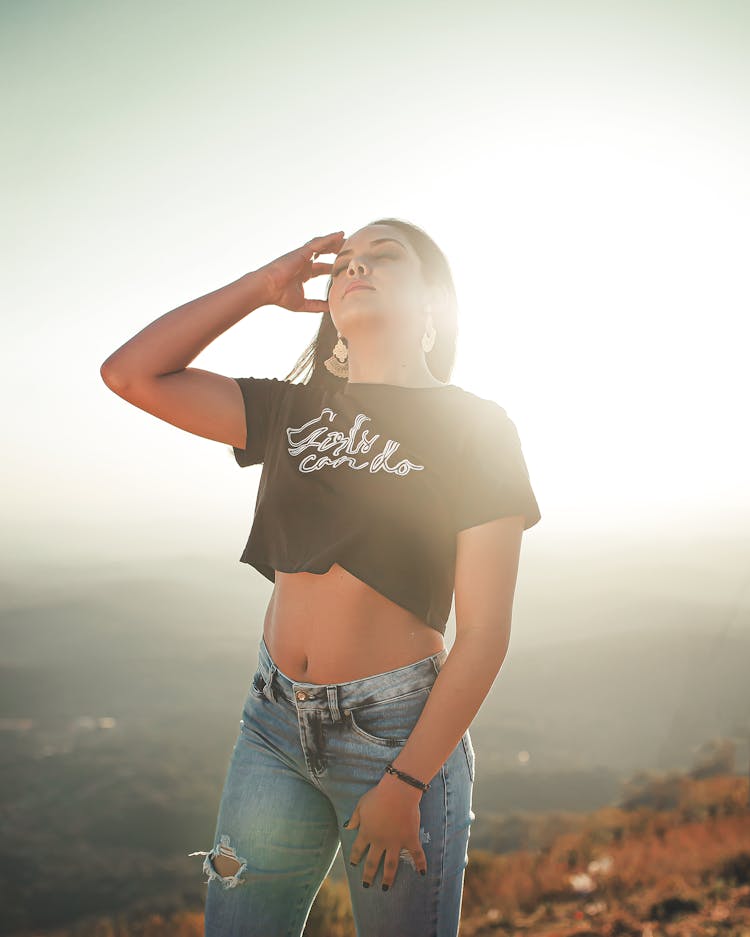 Girl Wearing A Crop Top Standing In The Sunlight 