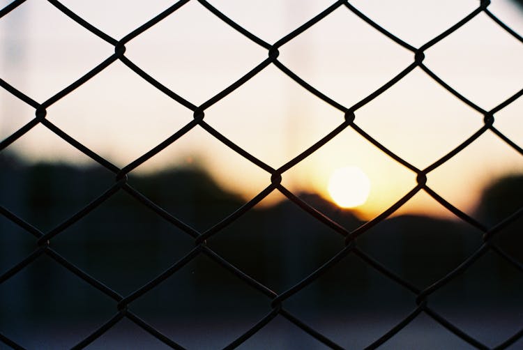 Net Fence At Sunset