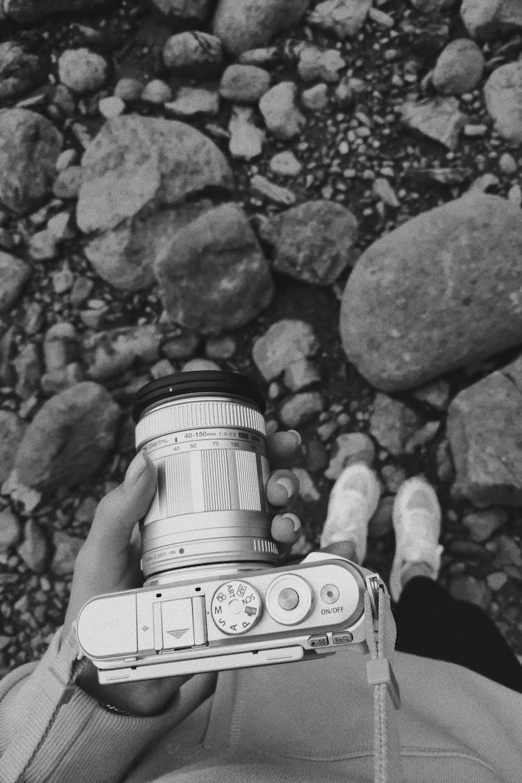 Person Holding Professional Camera In Hands