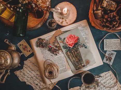 A curated vintage still life featuring antique elements, calligraphy, and postcards.