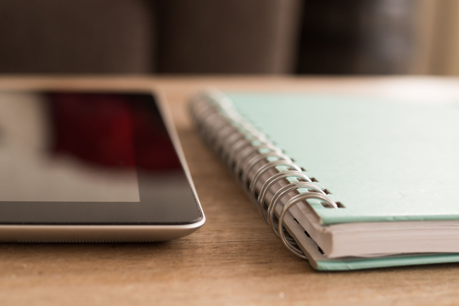 creative workspace with notebooks and digital tablet
