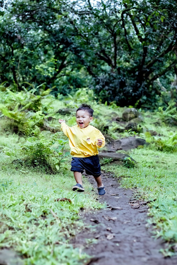 A Boy Running On A Trail