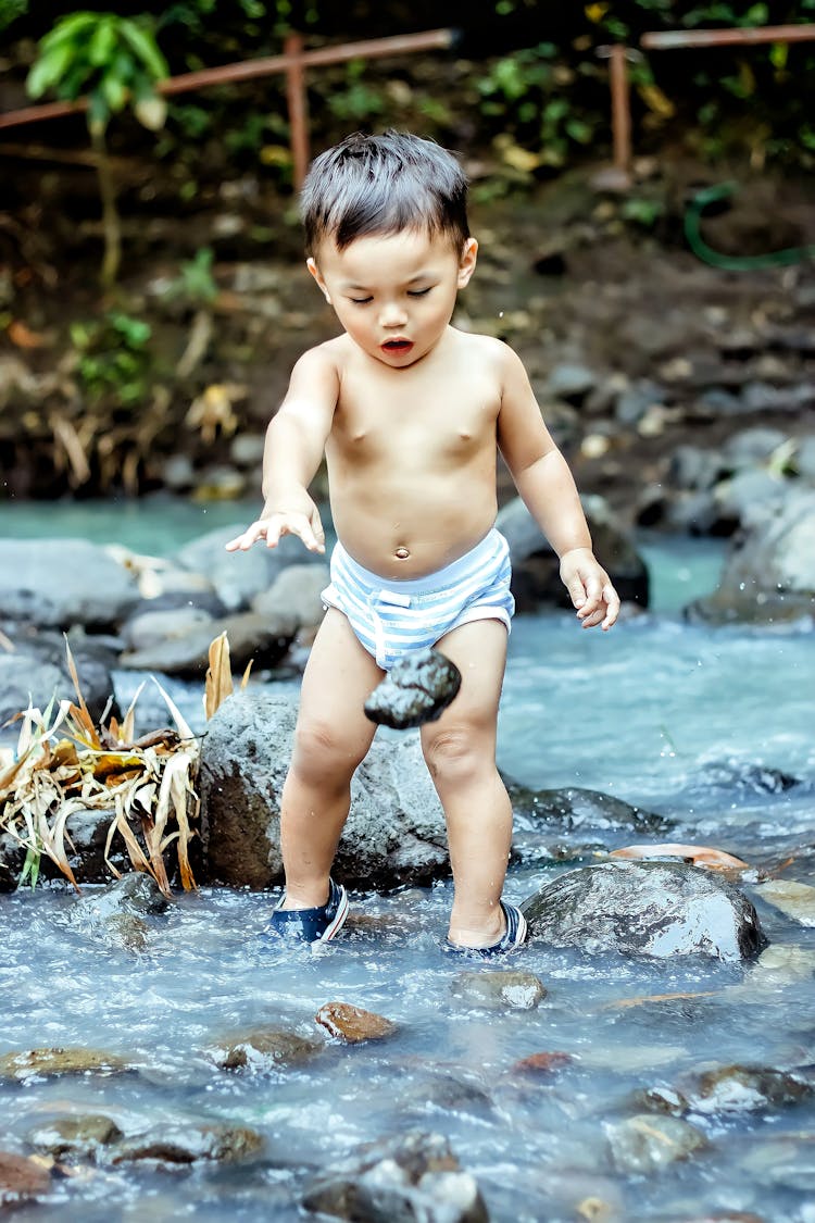 Photo Of A Child Throwing A Rock